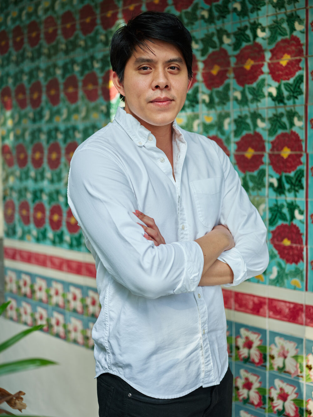 Fang Low, founder of Figment and The Straits Museum, photographed against the Peranakan tiles of a Singapore shophouse